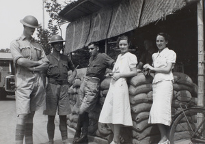 Women chatting with British Army soldiers at a roadside check point, Shanghai