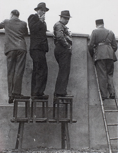 Journalists and a French Concession policeman watch fighting, Shanghai