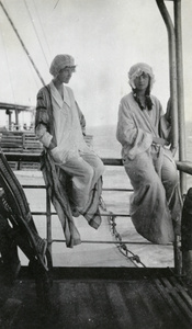 Two women in nightwear on board a ship
