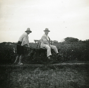 Chinese man travelling by wheelbarrow