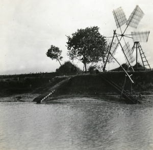 Windmill powered field flooding system
