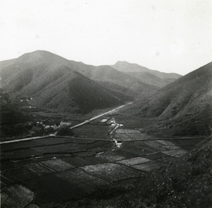 Fields, mountains and a road