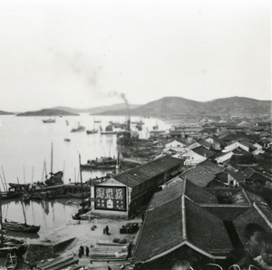 A small steamer and other boats at a seaside harbour, Hong Kong 