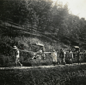 Two sedan chairs and bearers