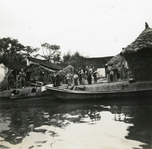 Officials and others watching a passing boat