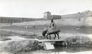 Crossing a bridge near city walls