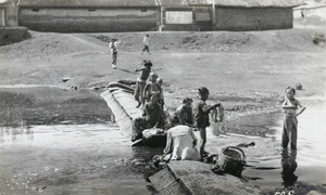 Washing laundry in a stream