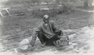 Old man with birdcage and fan