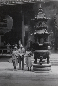 Freer and Connie Kelsey beside a very large incense burner and lanterns