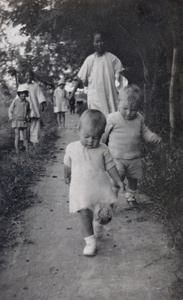 Chinese nursemaids walking with English children