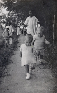 Chinese nursemaids walking with English children