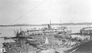 Junks and a steamship at China Navigation Company berth in Hankow