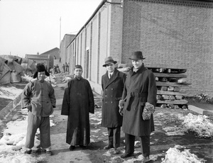 Group by a warehouse in Tianjin, including Ted McLaren