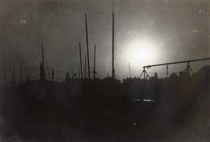 Silhouette of masts and buildings on a bund