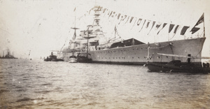 HMS Renown, dressed overall, at Hong Kong, during the Prince of Wales’ tour