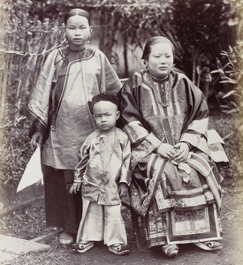 Two women and a boy, in a garden