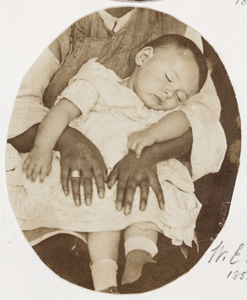 William Edward ('Little Willie') Vacher, asleep in the lap of an amah, Shanghai