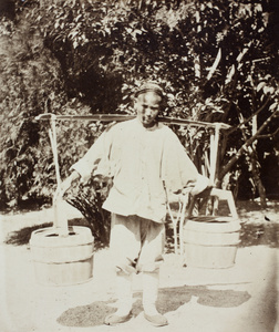 Water carrier, with pails, in a garden, Shanghai
