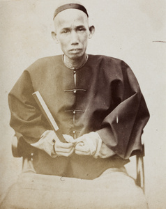 A bank shroff (coin cashier), with a fan, Shanghai