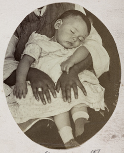 William Edward ('Little Willy') Vacher asleep on the lap of a Chinese woman