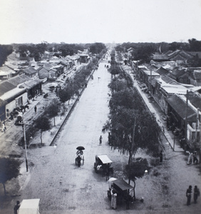 A tree-lined main street in Peking