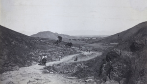 Visitors on a hillside road near Peking