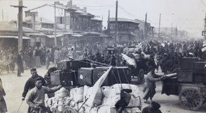 Hauling away goods on carts to save them from looters, Tianjin (Peking Mutiny, 1912)