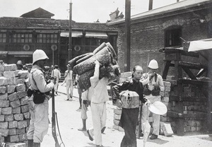 Leaving the Chinese City and entering the French Concession, Shanghai, at a checkpoint barrier, during the Xinhai Revolution