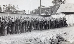 Convicts lined up in a prison stone breaking yard, Shanghai