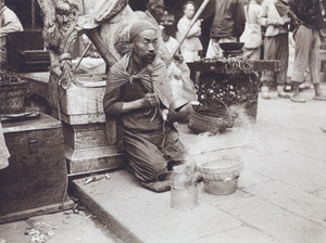 A blind beggar clanging a bell outside the City God Temple (上海城隍庙), Shanghai