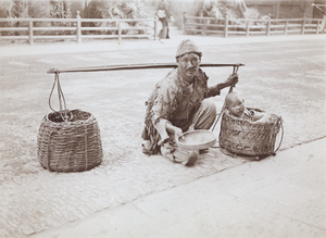 A beggar with a child in a pannier