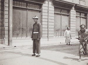 Chinese policeman, rickshaw driver and shop with dusty windows, Shanghai