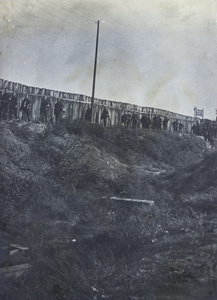 Revolutionary soldiers by a railway line fence