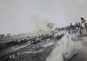 Civilians and revolutionary soldiers watching an engagement from a railway embankment